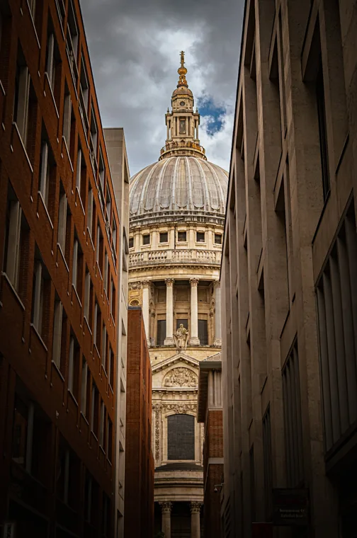 St Paul’s Cathedral seen between city buildings.